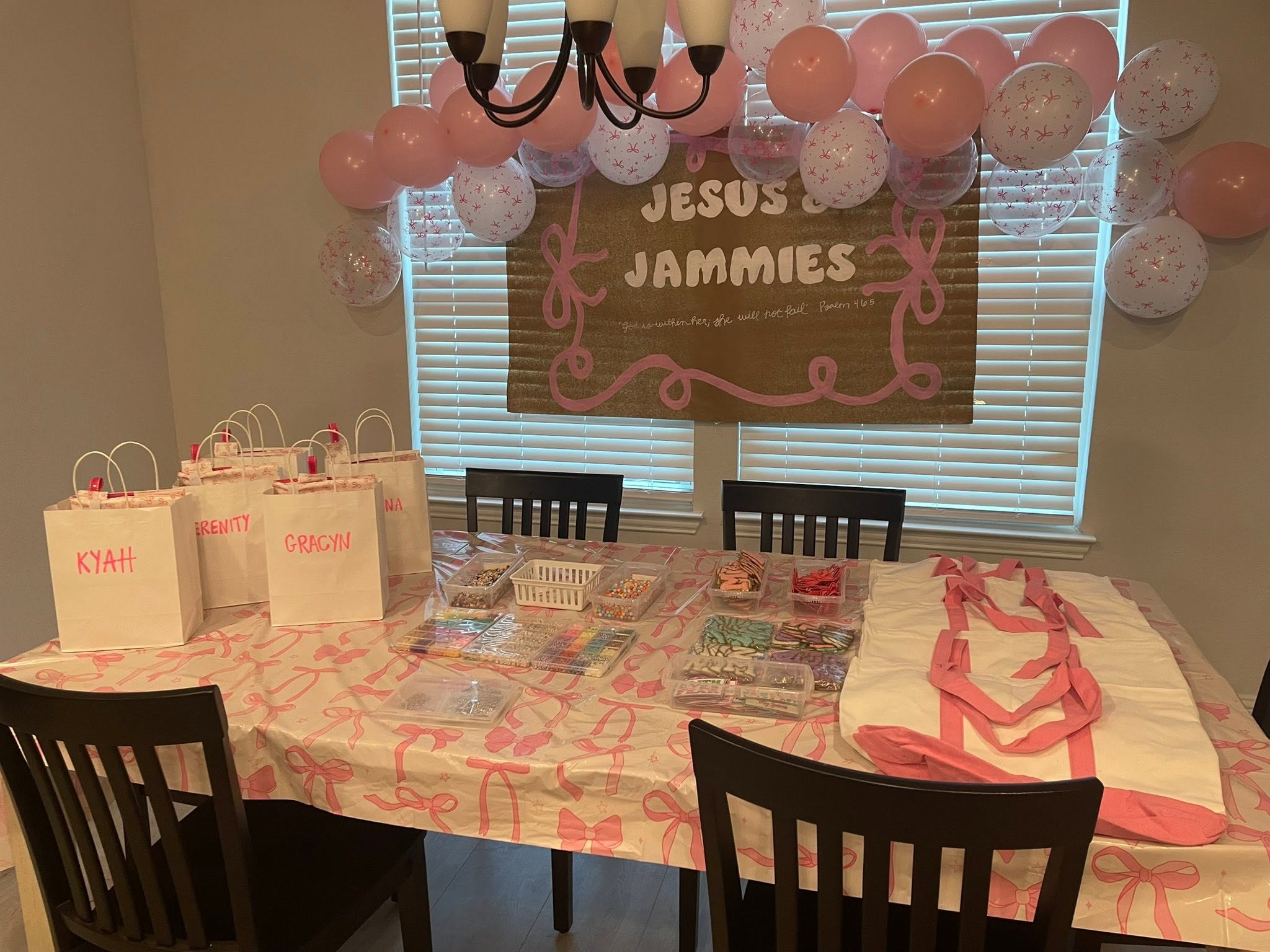 Table set up with name-labeled gift bags and crafts for the Jesus and Jammies event